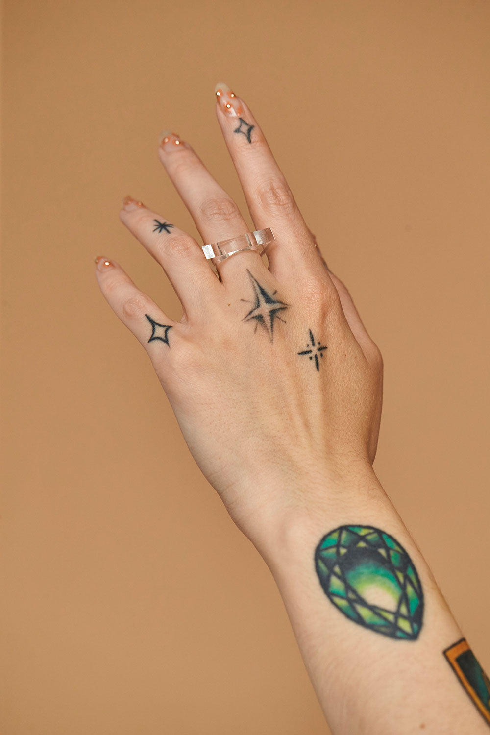 Angled view of the clear lucite Knockout self-defense ring