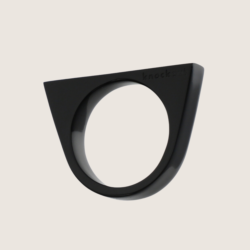 Black lucite Knockout self-defense ring with a pointed top