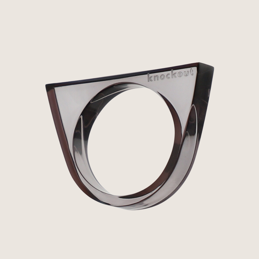 Clear and black lucite Knockout self-defense rings stacked together